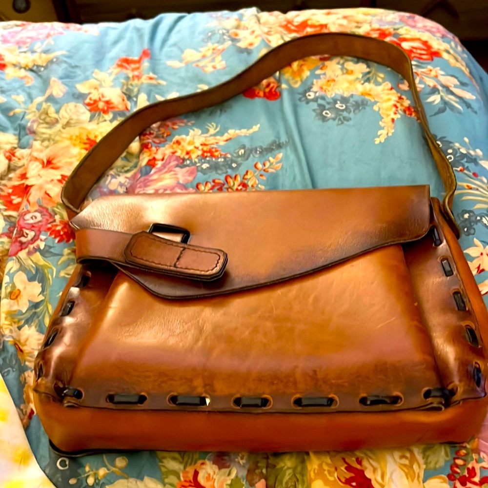 This is a handmade pocketbook made in Italy minor marks on bag from leather